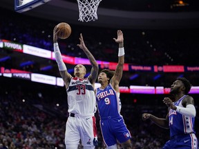 Washington Wizards' Kyle Kuzma (33) goes up for a shot against Philadelphia 76ers' Kelly Oubre Jr. (9) during the first half of an NBA basketball game, Monday, Nov. 6, 2023, in Philadelphia.