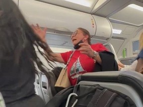 Screengrab of woman fighting with other passengers after trying to relieve herself in aisle mid-flight.