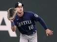 Seattle Mariners left fielder Jarred Kelenic reaches up to catch a flyout by Texas Rangers' Nathaniel Lowe.