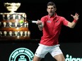 Serbia's Novak Djokovic returns the ball during the men's doubles semifinal tennis match between Italy and Serbia.