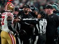 Dre Greenlaw of the San Francisco 49ers exchanges words with Philadelphia Eagles head coach Nick Sirianni and Dom DiSandro at Lincoln Financial Field.