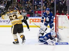 Boston Bruins winger Brad Marchand scores on Toronto Maple Leafs goaltender Joseph Woll in overtime.