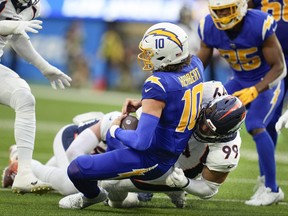 Denver Broncos defensive end Zach Allen sacks Los Angeles Chargers quarterback Justin Herbert.