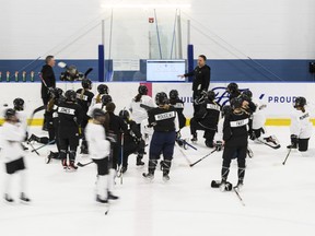 Coaches of Toronto's PWHL squad speak to players during training camp.