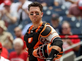 Catcher Buster Posey of the San Francisco Giants looks on against the Washington Nationals in 2021.