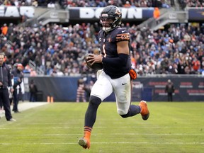Chicago Bears quarterback Justin Fields heads to the end zone for a touchdown against the Detroit Lions.
