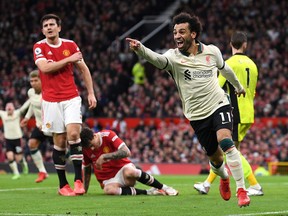 Mohamed Salah of Liverpool celebrates after scoring their side's third goal against Manchester United in 2021.