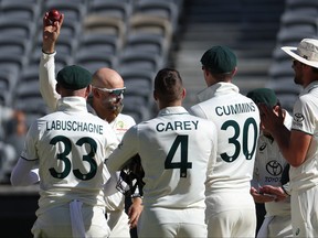 Australia's Nathan Lyon (2nd L) celebrates with teammates after taking his 500th wicket.