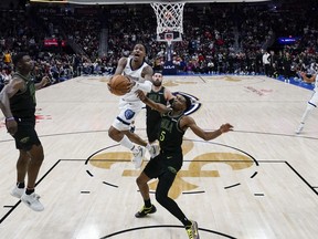 Memphis Grizzlies guard Ja Morant goes to the basket against New Orleans Pelicans forward Herbert Jones.