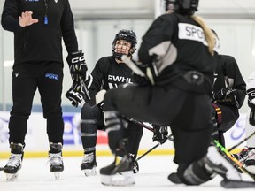 Forward Sarah Nurse listens while Troy Ryan, head coach speaks to players during the Professional Women's Hockey League’s training camp.