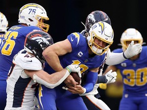Justin Herbert of the Los Angeles Chargers is sacked.