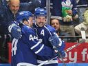Auston Matthews of the Toronto Maple Leafs (R) celebrates a goal against the New York Rangers during the second period in an NHL game at Scotiabank Arena on December 19, 2023 in Toronto, Ontario, Canada.