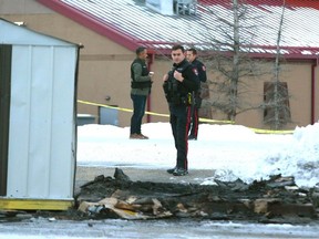 Calgary Police are shown at the scene of a fatal fire located in the parking lot of Rona at Crowfoot Crossing in northwest Calgary on Monday, December 11, 2023.