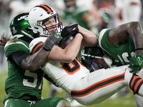 New York Jets tight end Kenny Yeboah is tackled by the New York Jets during the first half of an NFL football game Thursday, Dec. 28, 2023, in Cleveland.