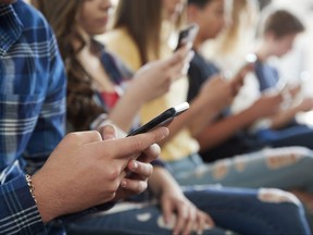 High school students use their smartphones in this file photo.