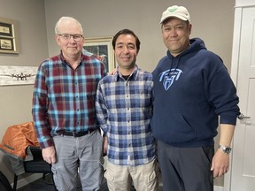 In this photo provided by Nikki Chung, Mohammad Hussain Musawi, centre, stands with his flight instructor, left, and Darin Chung, co-founder of the Afghan American Development Group, a nonprofit that helps former Afghan military aviation personnel with refugee resettlement assistance in the U.S., at a flight hangar in Independence, Ore. on April 7, 2023.