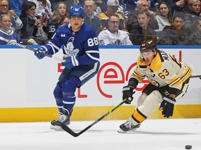 Bruins forward Brad Marchand, right, skates against Maple Leafs forward William Nylander during NHL action at Scotiabank Arena in Toronto, Saturday, Dec. 2, 2023.
