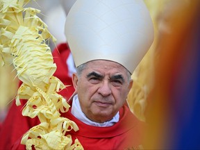 Italian Cardinal Giovanni Angelo Becciu takes par in the procession of the Palm Sunday mass on April 2, 2023 at St. Peter's square in The Vatican.