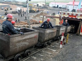 In this file photo released by China's Xinhua News Agency, miners enter the Jiayi Coal Mine in Jidong County of Jixi City, northeast China's Heilongjiang Province, Sunday, Sept. 23, 2012.