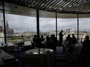 Clients enjoy a lunch at La Tour d'Argent restaurant in Paris, Wednesday, Dec. 13, 2023.
