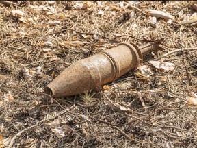 unexploded rusty projectile in the forest