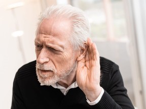 Portrait of senior man having hearing problems,