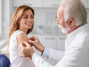 Doctor applying patch to patient after injecting vaccine