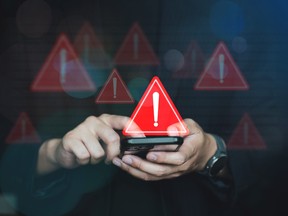 Emergency warning alert alarm on Smartphone, Data network protection, Virus alarm with people using computer.