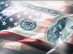 USA flag and American dollars. American flag blowing in the wind and 100 dollars banknotes in the background
