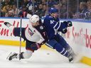 Columbus Blue Jackets centre Sean Kuraly (7) checks Toronto Maple Leafs defenceman Morgan Rielly (44) during third period NHL hockey action in Toronto on Thursday, December 14, 2023.