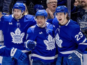 Maple Leafs centre Max Domi (centre) is congratulated by teammates Matthew Knies (right) and William Lafesson (left) after scoring during second period NHL action against the Penguins in Toronto, Saturday, Dec. 16, 2023.