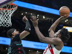 Toronto Raptors forward O.G. Anunoby, right, shoots over Washington Wizards centre Daniel Gafford during the first half of an NBA basketball game Wednesday, Dec. 27, 2023, in Washington, D.C.