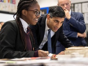 U.K. Prime Minister Rishi Sunak talks with a pupil in a year 10 art class at Wren Academy in Finchley, north London, Thursday, Dec. 14, 2023.