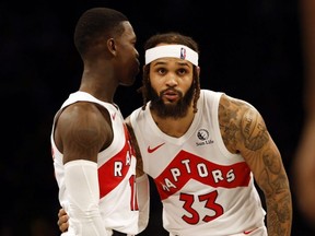 Raptors' Dennis Schroder left talks with Gary Trent Jr. during NBA actiont against the Nets at Barclays Center in Brooklyn, N.Y., Nov. 28, 2023.