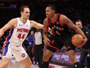 Scottie Barnes of the Toronto Raptors tries to drive around Bojan Bogdanovic of the Detroit Pistons during the second half at Little Caesars Arena on Dec. 30, 2023 in Detroit.