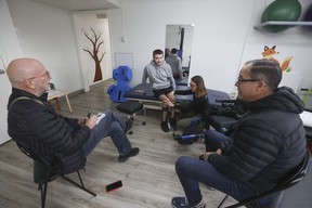 Keenan Sadler, 17, who doesn't let his cerebral palsy or a recent broken left femur get him down, is seen here getting physio from Stephanie So at Variety Village while his dad and Mike Strobel watch on Wednesday December 6, 2023.