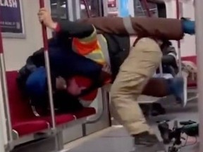 Screengrab of two men fighting on TTC subway train.
