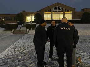 Albany police officers gather outside Temple Israel