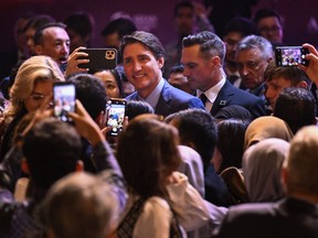 Justin Trudeau in crowd, taking selfies