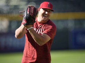 FILE - Los Angeles Angels center fielder Mike Trout warms up before a baseball game against the Colorado Rockies, Saturday, June 24, 2023, in Denver. The Angels will not trade three-time AL MVP Mike Trout. General manager Perry Minasian confirmed it at MLB's winter meetings.