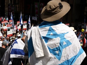 Members of the Australian Jewish community hold flags and placards during a pro-Israel rally in Sydney on Nov. 26, 2023.