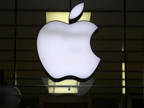 The Apple logo is illuminated at a store in the city centre of Munich, Germany, Dec. 16, 2020.
