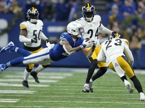 Indianapolis Colts wide receiver Michael Pittman Jr. (11) catches a pass before being hit by Pittsburgh Steelers safety Damontae Kazee (23) during the first half of an NFL football game in Indianapolis Saturday, Dec. 16, 2023. Pittman was injured on the play and Kazee was ejected from the game.