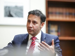 Justice Minister Arif Virani takes part in an interview in Ottawa on Wednesday, Dec. 13, 2023.