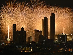 Fireworks explode over the city skyline along the Chao Phraya River during New Year's Eve celebrations in Bangkok on Jan. 1, 2024.