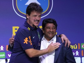 FILE - Fernando Diniz, left, the new head coach of the Brazil's national soccer team, and Brazilian Soccer Confederation President Ednaldo Rodrigues, right, embrace during a media presentation in Rio de Janeiro, Brazil, July 5, 2023. A Rio de Janeiro state court has removed Rodrigues from office because of irregularities in the proceedings that led to his election last year.