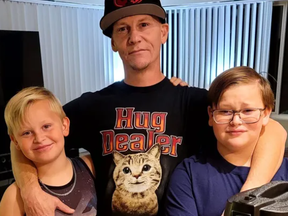 Brian Lewis is pictured in a GoFundMe photo with his two sons, one of whom, Henry, died in a fire.