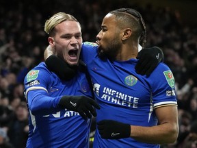Chelsea's Mykhailo Mudryk, left, celebrates with teammate Chelsea's Christopher Nkunku after scoring his sides first goal of the game during the English League Cup quarterfinal soccer match between Chelsea and Newcastle United at Stamford Bridge in London, Tuesday, Dec. 19, 2023.