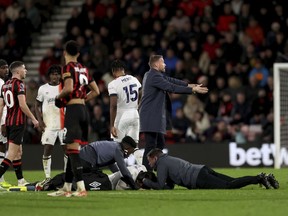Luton Town manager Rob Edwards gestures on the pitch as his player Tom Lockyer receives treatment on the pitch during the English Premier League soccer match between Bournemouth and Luton Town at the Vitality Stadium, in Bournemouth, England, Saturday, Dec. 16, 2023.