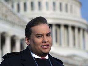Rep. George Santos, R-N.Y., faces reporters at the Capitol in Washington, early Thursday, Nov. 30, 2023. After a scathing report by the House Ethics Committee citing egregious violations, Santos could be expelled from Congress this week.
